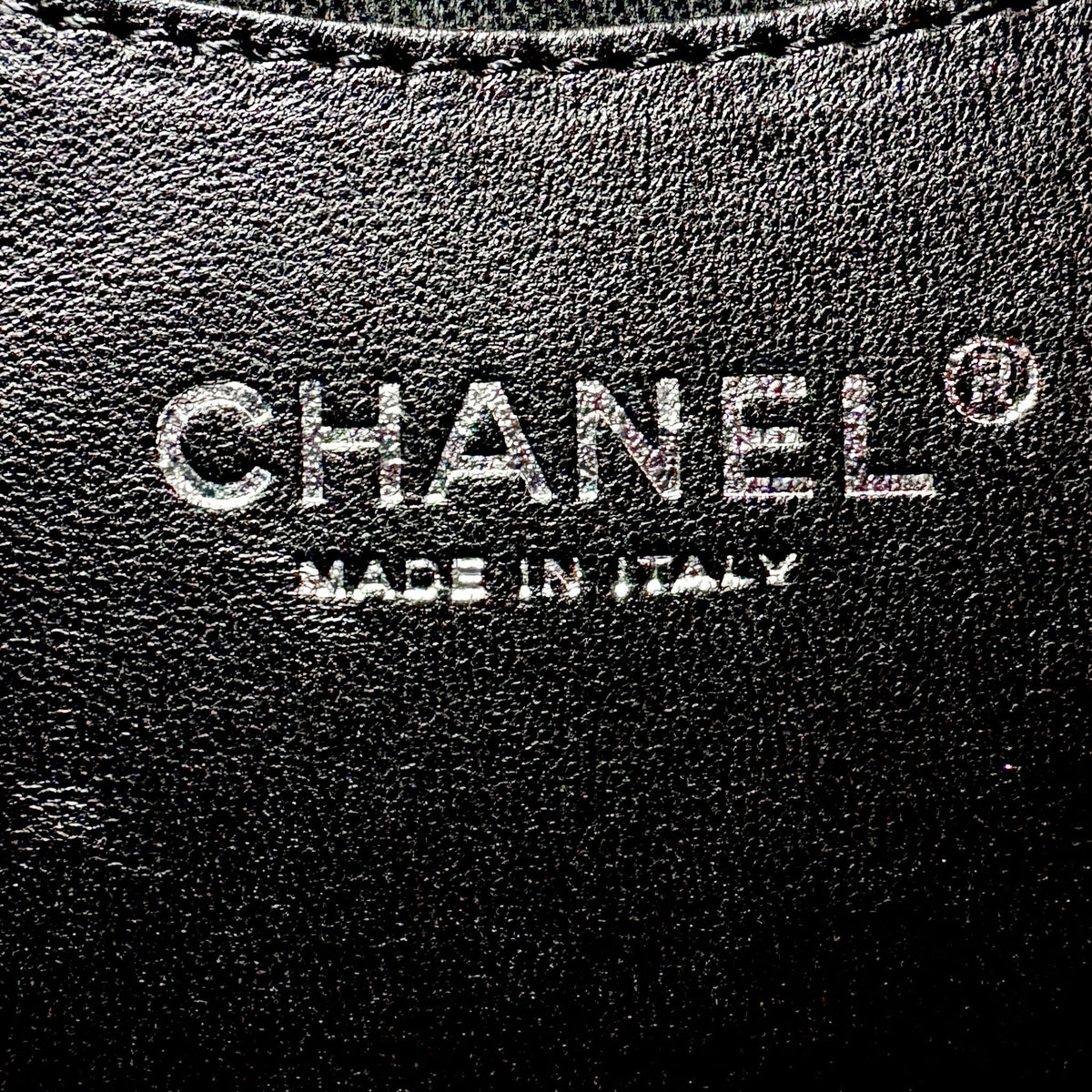 Studio61 Preloved Boutique Sydney Chanel logo embossed on black leather interior of a luxury handbag