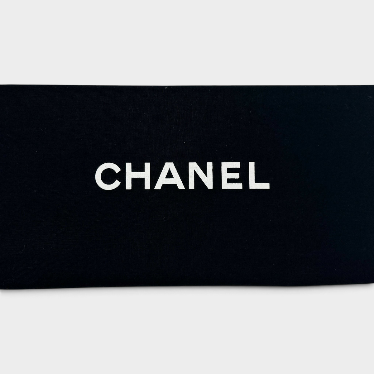 Studio61 Preloved Boutique Sydney Chanel brand logo in white text on a black fabric dust bag